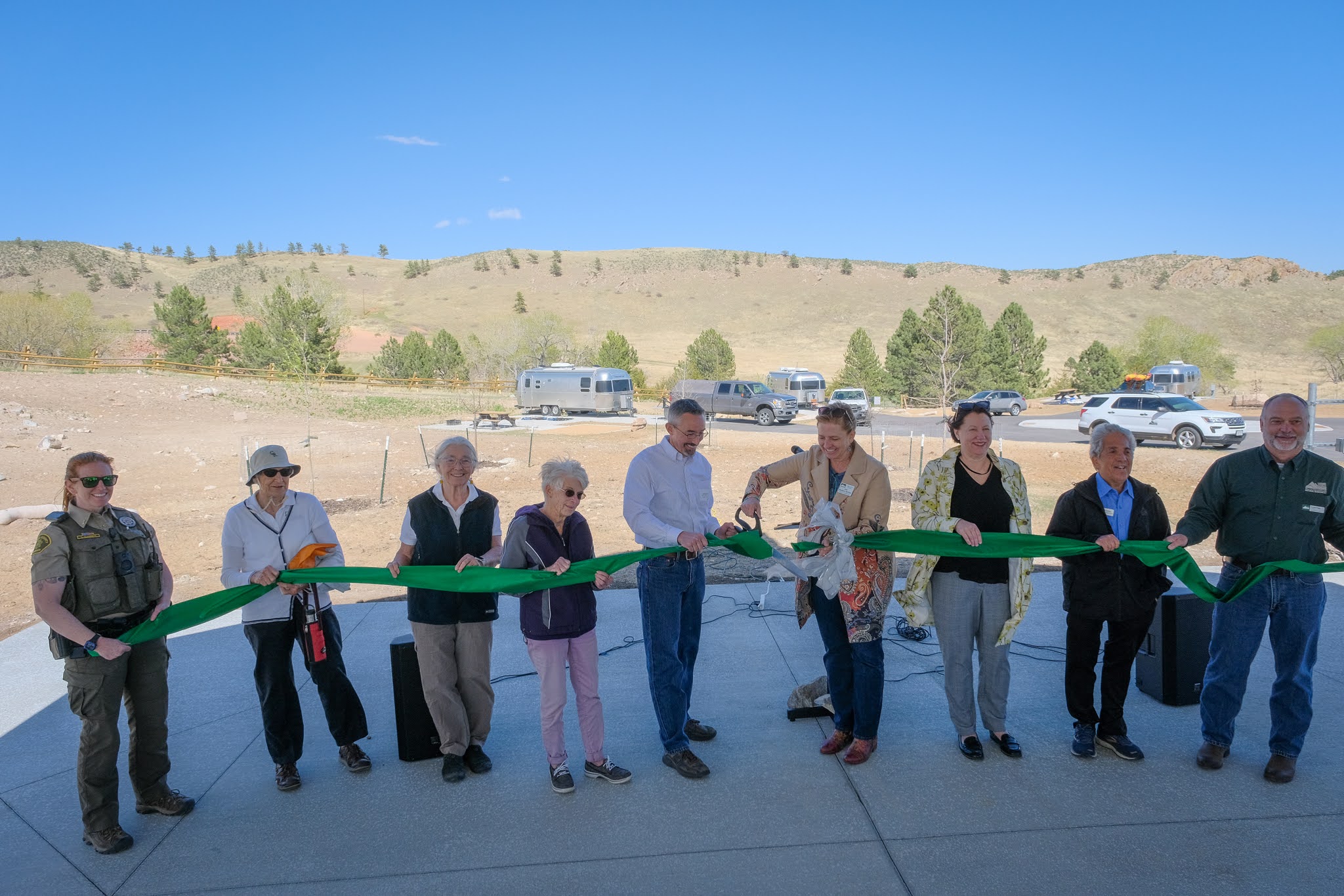 Image 4: Officials gather to cut the ribbon to open Sky View Campground on May 12, 2022.