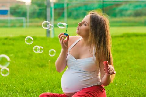 pregnant woman blowing bubbles